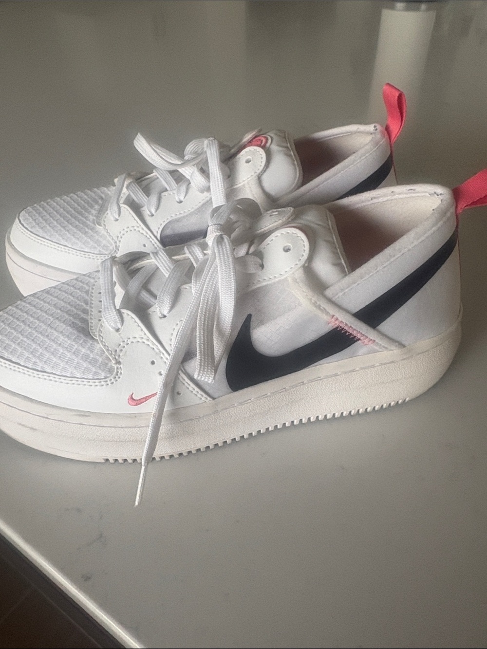 Nike Women’s White Sneakers with Black Swoosh and Pink Pull Tab